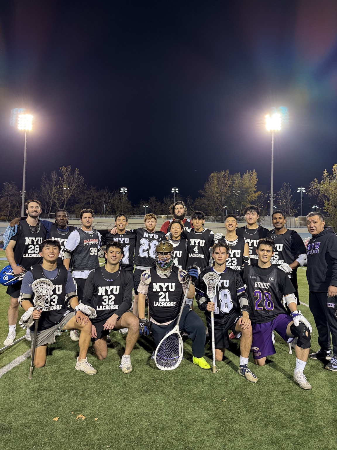 Leo Fisher with NYU teammates on the field